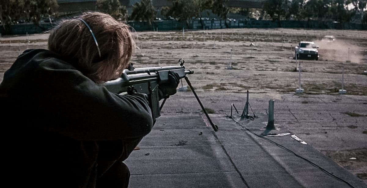 Chris with an HK91 A2 rifle in the drive-in theater meeting scene in Heat (1995)