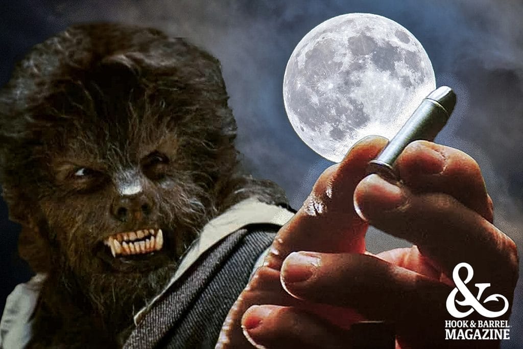 A werewolf with the full moon in the background and a hand holding a silver bullet